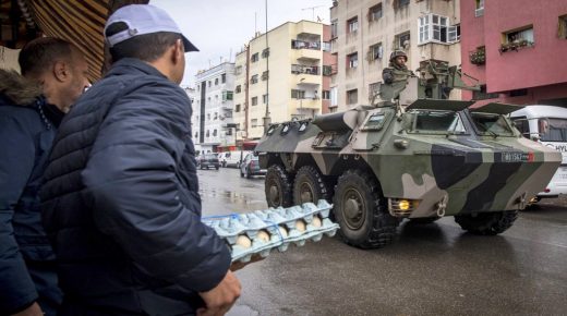 A Moroccan military armoured personnel carrier (APC) drives along a street in Sale, north of the capital Rabat, on March 24, 2020, instructing people to return to and remain at home as a measure against the COVID-19 coronavirus pandemic. (Photo by FADEL SENNA / AFP)